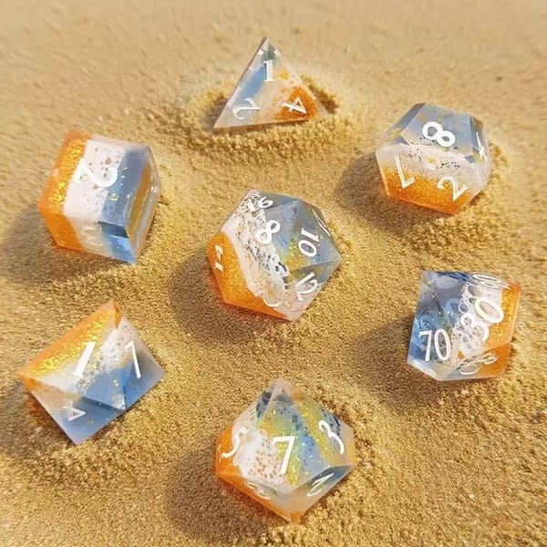 In-stock sharp-edge resin dice in blue and orange with gold foil and white numbers