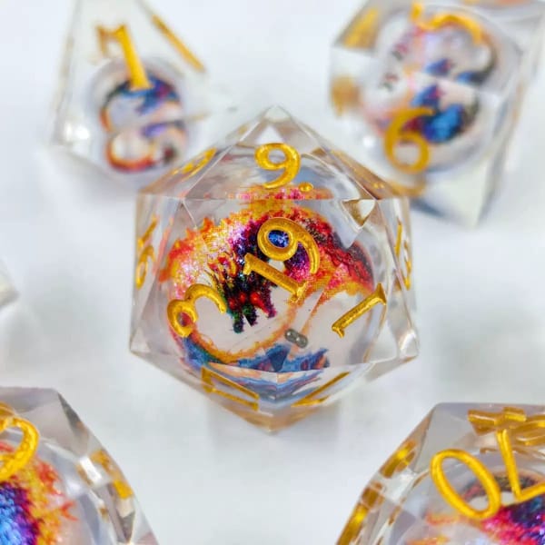 In-stock sharp-edge resin dice with a clear galaxy nebula liquid core and gold numbers
