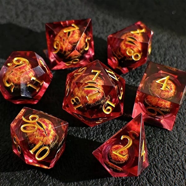 In-stock sharp-edge resin dice in red with a moving eye liquid core and gold numbers